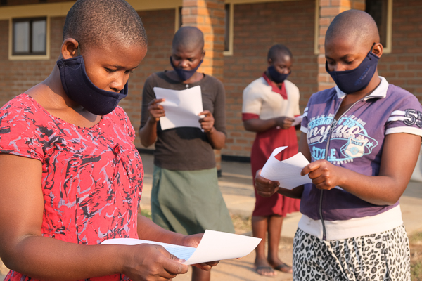 Image of Kuwala students reading letters from Canada