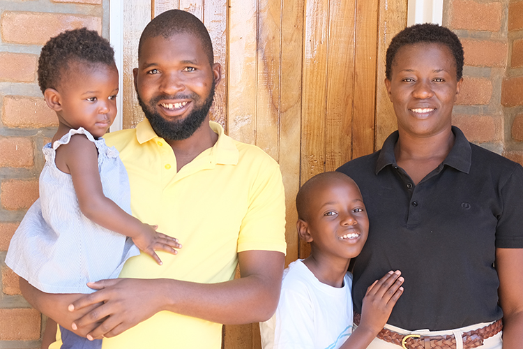 McSensio’s family portrait taken outside their door leading to their newly built staff house.