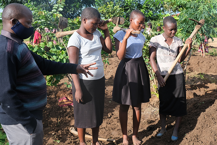 Image of Kuwala teacher instructing the students in proper tree placement and spacing. 