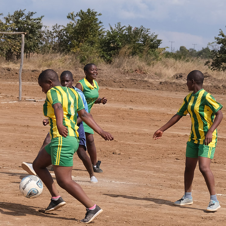 Action shot of Kuwala students playing soccer. 