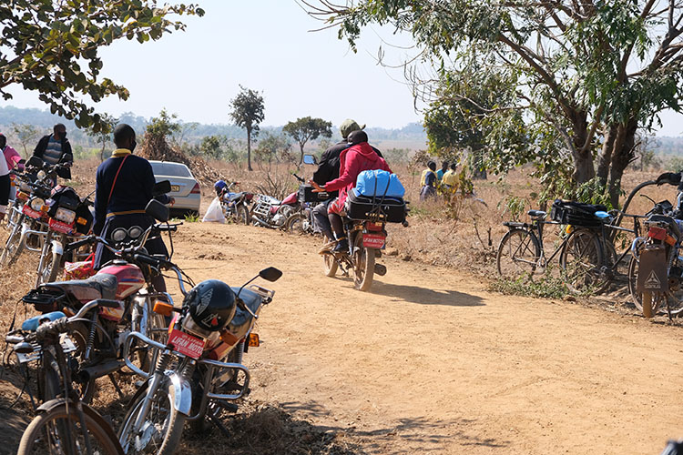 Motorbikes picking up students at the Kuwala Campus.