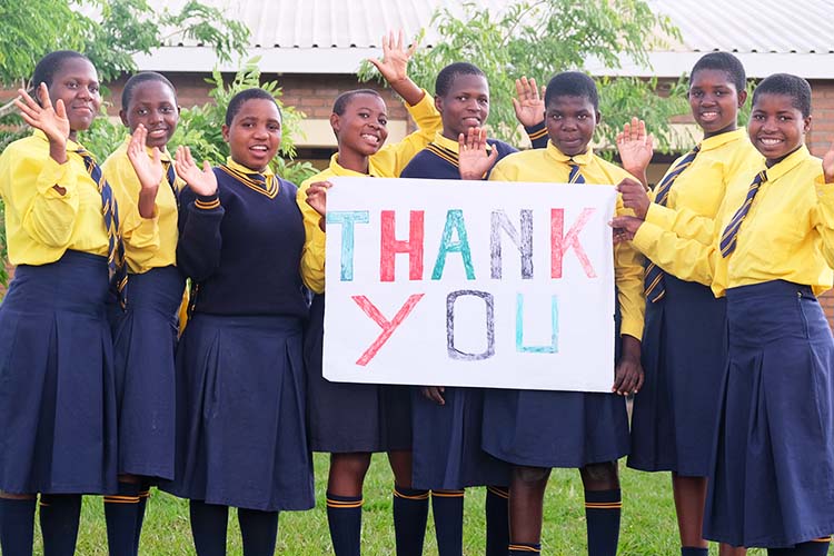 Kuwala students helped craft a large personalized thank you card for the sponsors back in Canada.