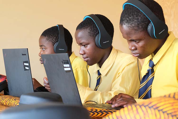 Kuwala students in the computer lab studying on laptops.