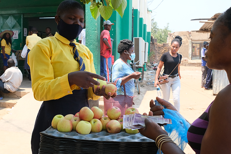 Student visiting a local fruit stand on the way to Savannah Beach. 