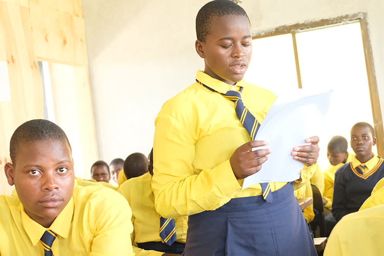 Kuwala student Olive reading a scripture to the class