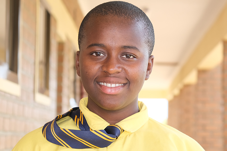 Student Olive outside classroom block