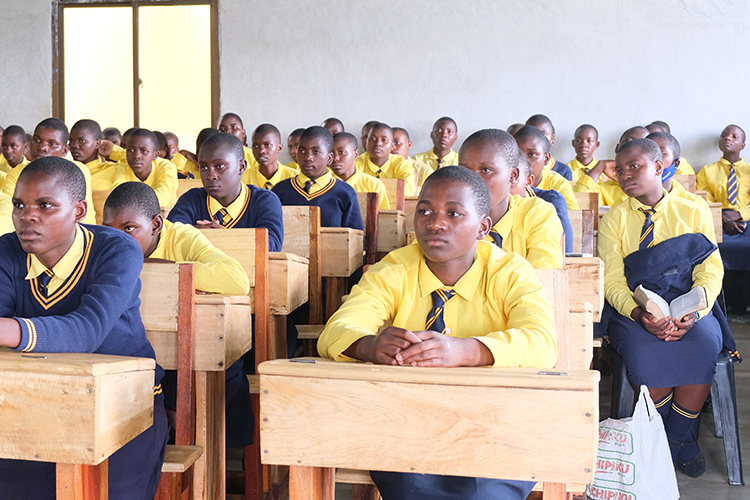 Students in class and using the St. Peter's Assembly Hall for a temporary space.