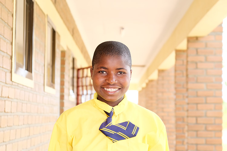 Takondwa is a 4th Form student photographed outside classroom block one.