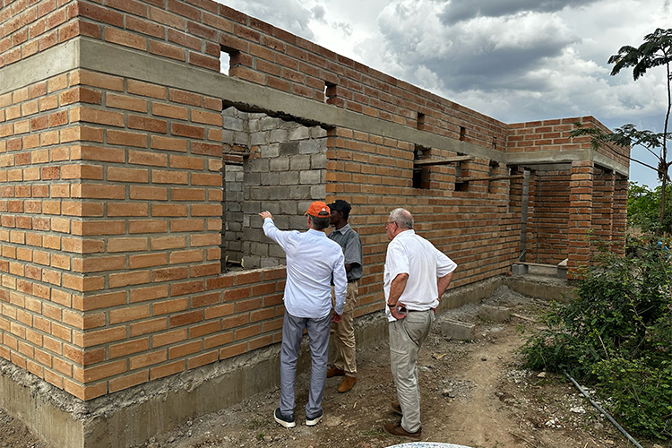 Building construction showing open windows and brick walls