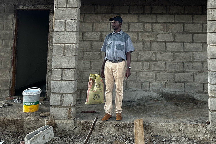 Henry Mdyetseni standing inside the incomplete Maize grinding building.