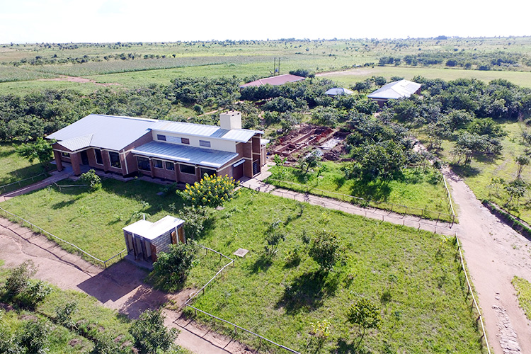 Arial shot of St. Peter's Assembly Hall with biogas foundation outside the kitchen in the back.