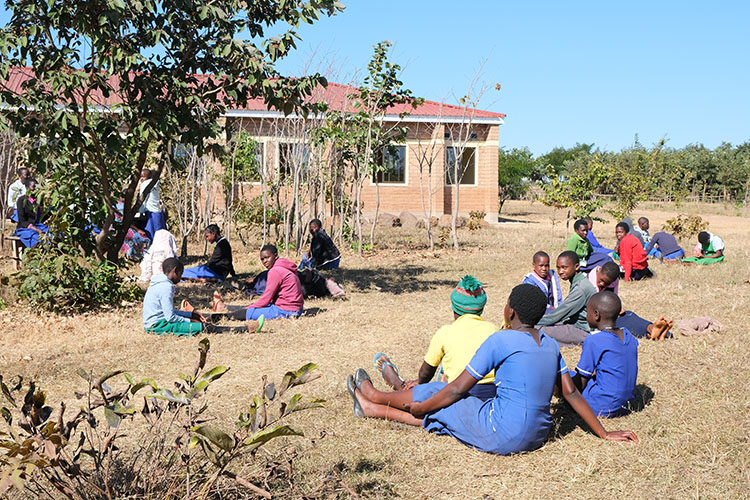 Student candidates siting on lawn of Campus outside the classroom block waiting for their interview.