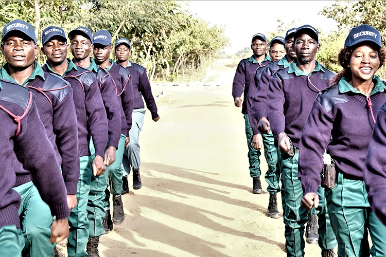 Kuwala security guards marching outdoors in the morning. 