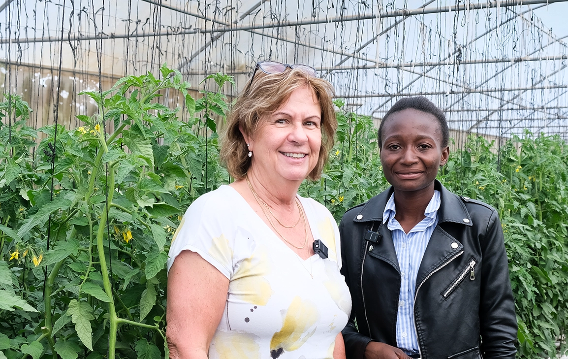 Ruth and the Kuwala Farm Manager inside the greenhouse.