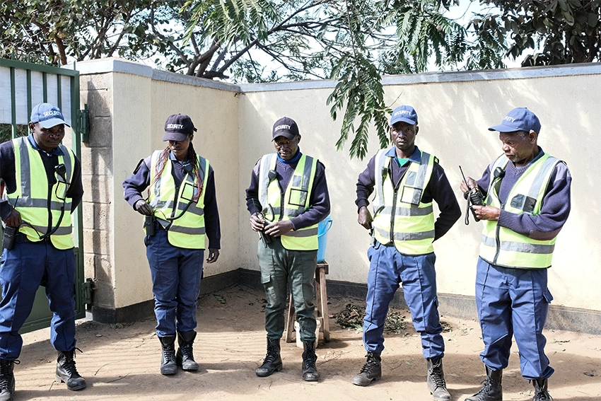 Kuwala security staff outside the Kuwala main gates holding their new radios.