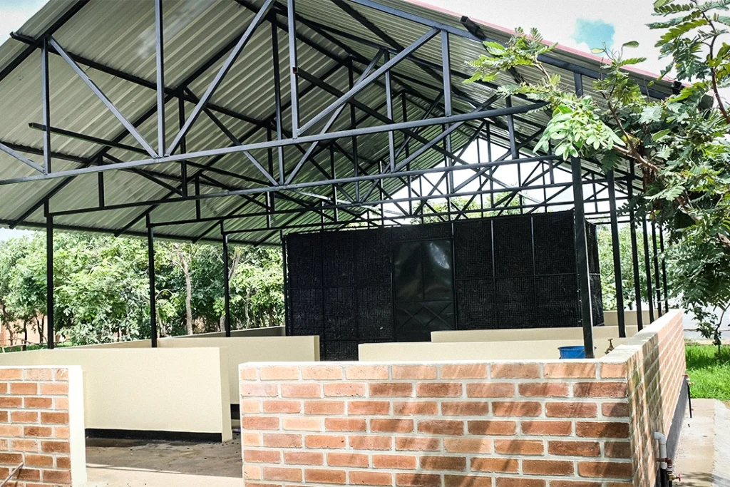 Kuwala's new Preservation Buildiing under construction showing the characoal wall for evaporative cooling.